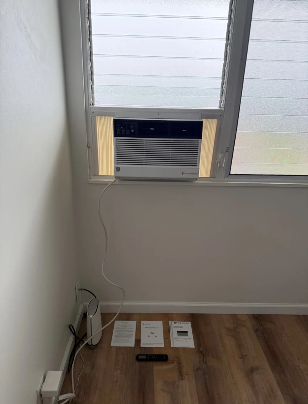 Friedrich air conditioner installed beneath a jalousie window